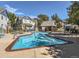 Community pool with chairs and tables surrounded by well maintained buildings and landscaping at 12961 Lafayette St # B, Thornton, CO 80241