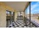 Private balcony featuring checkered floors and glass windows overlooking neighborhood at 6980 E Girard Ave # 204, Denver, CO 80224