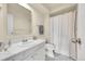 Clean bathroom featuring a large mirror, white vanity, and shower with curtain at 6980 E Girard Ave # 204, Denver, CO 80224