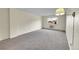 Cozy bedroom featuring neutral carpet, natural light from the window, and baseboard heating at 6980 E Girard Ave # 204, Denver, CO 80224