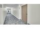 Carpeted hallway leading to unit 204 in a well-maintained apartment building at 6980 E Girard Ave # 204, Denver, CO 80224