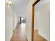 Bright hallway with laminate flooring leading towards a sunroom with a view at 6980 E Girard Ave # 204, Denver, CO 80224