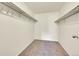 Spacious walk-in closet with carpet flooring and shelving for optimal storage at 6980 E Girard Ave # 204, Denver, CO 80224