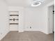 Empty bedroom featuring neutral carpet, built in shelving, and modern ceiling light at 1617 California St # 3B, Denver, CO 80202