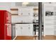 Kitchen with stainless steel oven, microwave, black countertops and retro refrigerator at 1617 California St # 3B, Denver, CO 80202