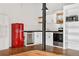 Bright kitchen featuring white cabinets, a stainless steel dishwasher and range, and a retro red refrigerator at 1617 California St # 3B, Denver, CO 80202