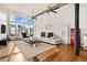 Open-concept living room featuring a modern white sofa, a red refrigerator, and hardwood floors at 1617 California St # 3B, Denver, CO 80202