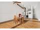 Open living space with ceiling fans, hardwood floors, a table with four chairs, and kitchen area at 1617 California St # 3B, Denver, CO 80202