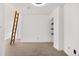 Small loft bedroom with carpet, ladder access and built-in shelving at 1617 California St # 3B, Denver, CO 80202