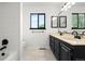Updated bathroom with dual sinks, modern fixtures, and bright marble floors at 4906 S Crystal St, Aurora, CO 80015