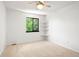 Spacious carpeted bedroom with window, shelving, and a ceiling fan at 4906 S Crystal St, Aurora, CO 80015