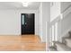 Bright entryway with wood flooring, a black front door with stained glass and white accents at 4906 S Crystal St, Aurora, CO 80015