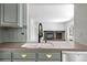 Modern kitchen with stainless steel appliances, kitchen sink and view to the living room at 4906 S Crystal St, Aurora, CO 80015