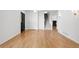 Open living room featuring hardwood floors, a staircase with carpeted steps, and bright white accents at 4906 S Crystal St, Aurora, CO 80015