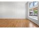 Bright living room featuring hardwood floors, decorative wall trim, a tall window and window seating at 4906 S Crystal St, Aurora, CO 80015