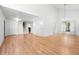 Spacious living room with hardwood floors, white walls, and modern light fixtures, and a staircase at 4906 S Crystal St, Aurora, CO 80015