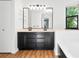 Large main bathroom with double vanity, soaking tub, and a large mirror at 4906 S Crystal St, Aurora, CO 80015