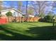Lush green backyard featuring a wooden fence, arbor, and meticulously maintained lawn, ideal for outdoor enjoyment at 5740 S Delaware St, Littleton, CO 80120