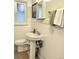 Bathroom with pedestal sink, updated fixtures, and classic tiling at 5740 S Delaware St, Littleton, CO 80120