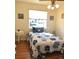 Comfortable bedroom featuring hardwood floors and a patterned comforter at 5740 S Delaware St, Littleton, CO 80120