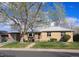 Charming one-story home with a well-maintained lawn, mature trees, and brick exterior at 5740 S Delaware St, Littleton, CO 80120