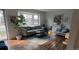 Cozy living room featuring hardwood floors, comfortable seating, and a bright bay window at 5740 S Delaware St, Littleton, CO 80120