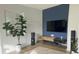 Stylish living room with a large TV, hardwood floors, and a large green plant at 5740 S Delaware St, Littleton, CO 80120