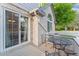 Back patio with brick facade, metal furniture set, and sliding door to interior at 1385 W 112Th Ave # D, Denver, CO 80234