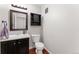 Updated bathroom with dark wood vanity, updated hardware, and a neutral color scheme at 1385 W 112Th Ave # D, Denver, CO 80234