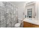 Bathroom with modern vanity, neutral countertops, and shower with patterned curtain at 1385 W 112Th Ave # D, Denver, CO 80234