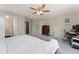 Bright bedroom with ceiling fan, ensuite bathroom, and home office area at 1385 W 112Th Ave # D, Denver, CO 80234