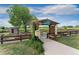 Charming community gardens with raised beds, a pergola entrance, and lush greenery at 1385 W 112Th Ave # D, Denver, CO 80234