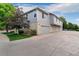 Inviting exterior featuring a well-maintained lawn, attached garages, and architectural details at 1385 W 112Th Ave # D, Denver, CO 80234