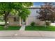 Charming home featuring a well-maintained lawn and an inviting entrance with beautiful mature trees at 1385 W 112Th Ave # D, Denver, CO 80234