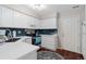Bright kitchen with white cabinets, stylish backsplash, stainless steel appliances, and wood floors at 1385 W 112Th Ave # D, Denver, CO 80234