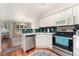 Modern kitchen with stainless steel appliances, white cabinets, and backsplash at 1385 W 112Th Ave # D, Denver, CO 80234