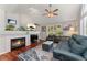 A cozy living room featuring a fireplace, TV, vaulted ceiling, and an open concept layout at 1385 W 112Th Ave # D, Denver, CO 80234