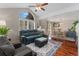 Bright living room featuring vaulted ceilings, oversized window, and an open floor plan to the dining room at 1385 W 112Th Ave # D, Denver, CO 80234