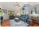 Inviting living room with vaulted ceiling, ceiling fan, shutters, and wood flooring at 1385 W 112Th Ave # D, Denver, CO 80234