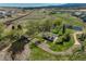 Expansive property featuring multiple ponds, mature trees, and lush greenery for privacy and serenity at 16440 Old Denver Rd, Monument, CO 80132