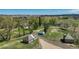 Stunning aerial view of the property, showcasing multiple buildings, mature trees, ponds, and sprawling green spaces at 16440 Old Denver Rd, Monument, CO 80132