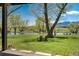 Backyard featuring an outdoor seating area on a lawn overlooking a pond and mountains at 16440 Old Denver Rd, Monument, CO 80132