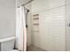 Modern bathroom featuring white subway tile and a shower with a built-in niche and hexagon tile floor at 16440 Old Denver Rd, Monument, CO 80132