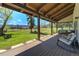 Inviting covered porch with comfortable seating and scenic views of the sprawling backyard at 16440 Old Denver Rd, Monument, CO 80132