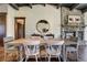 Dining room with stone fireplace, hardwood floors, and circular mirror at 16440 Old Denver Rd, Monument, CO 80132