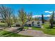 Charming home boasting a well-manicured lawn, dormer windows, large trees, and a welcoming front entrance at 16440 Old Denver Rd, Monument, CO 80132