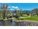 Beautiful home featuring an attached garage, pond, luscious green grass, and mountain views on a bright sunny day at 16440 Old Denver Rd, Monument, CO 80132