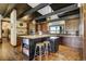 Beautiful kitchen with beamed ceilings, center island with seating, and stainless steel appliances at 16440 Old Denver Rd, Monument, CO 80132