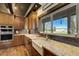 Kitchen with countertops, farmhouse sink, and stainless steel appliances at 16440 Old Denver Rd, Monument, CO 80132