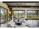 Inviting living room with water view, featuring beamed ceilings and cozy seating arrangement at 16440 Old Denver Rd, Monument, CO 80132